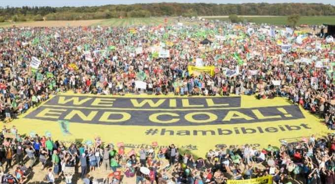 50 000 people participate in the demonstration at the Hambacher Wald near Koeln-Buir for a quick coal phase-out and for the rescue of the Hambacher Forest. The demonstration "Save forest-stop coal" near the forest is the largest of its kind so far. The initiative Buirer for Buir, the German Federal Association for the Environment and Nature Conservation (BUND), Campact, Greenpeace and the nature friends of Germany are calling for a fast exit from coal. They demand energy group RWE to definitively stop logging in the Hambach Forest. The banner reads: "We will end coal. #hambibleibt." (Photo: Bernd Arnold/Greenpeace)