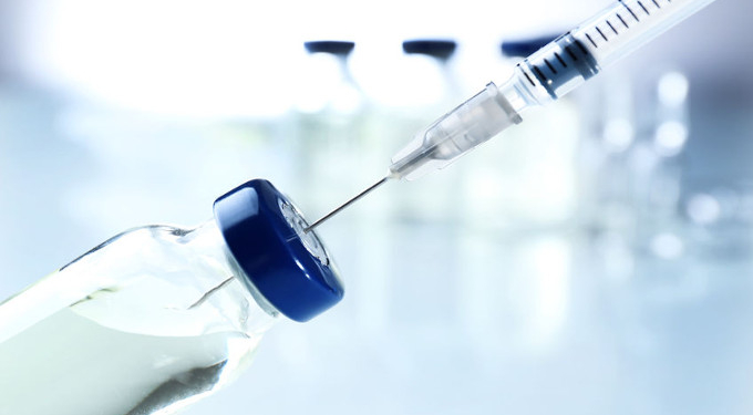 Vaccine in vial with syringe