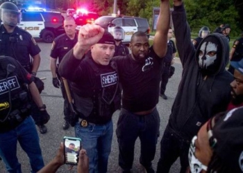 Police Officers Join Protesters Marching Against Brutality In Some Cities